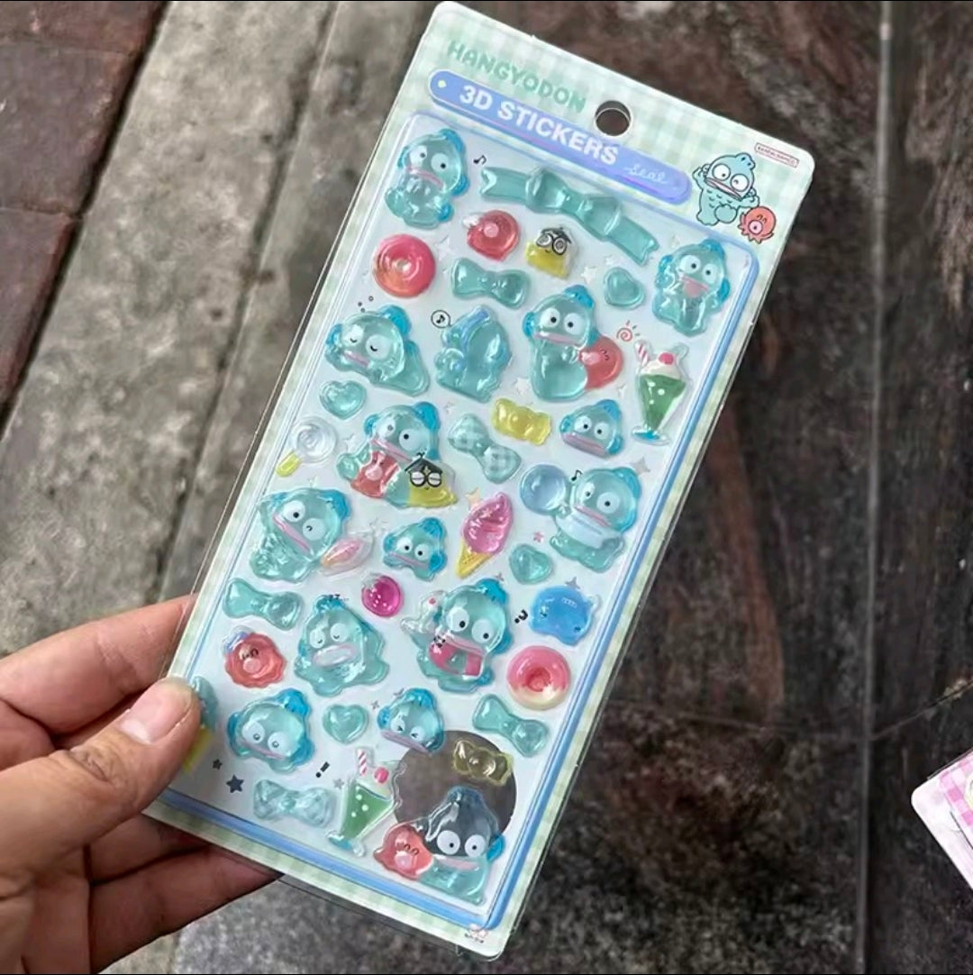3D acrylic sticker set with teal, pink, and blue cute character charms on a card