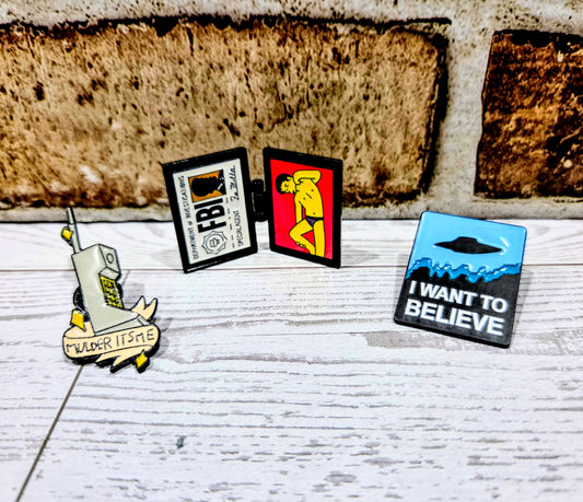 Enamel pin set of three themed badges and charms, including phone and FBI badge