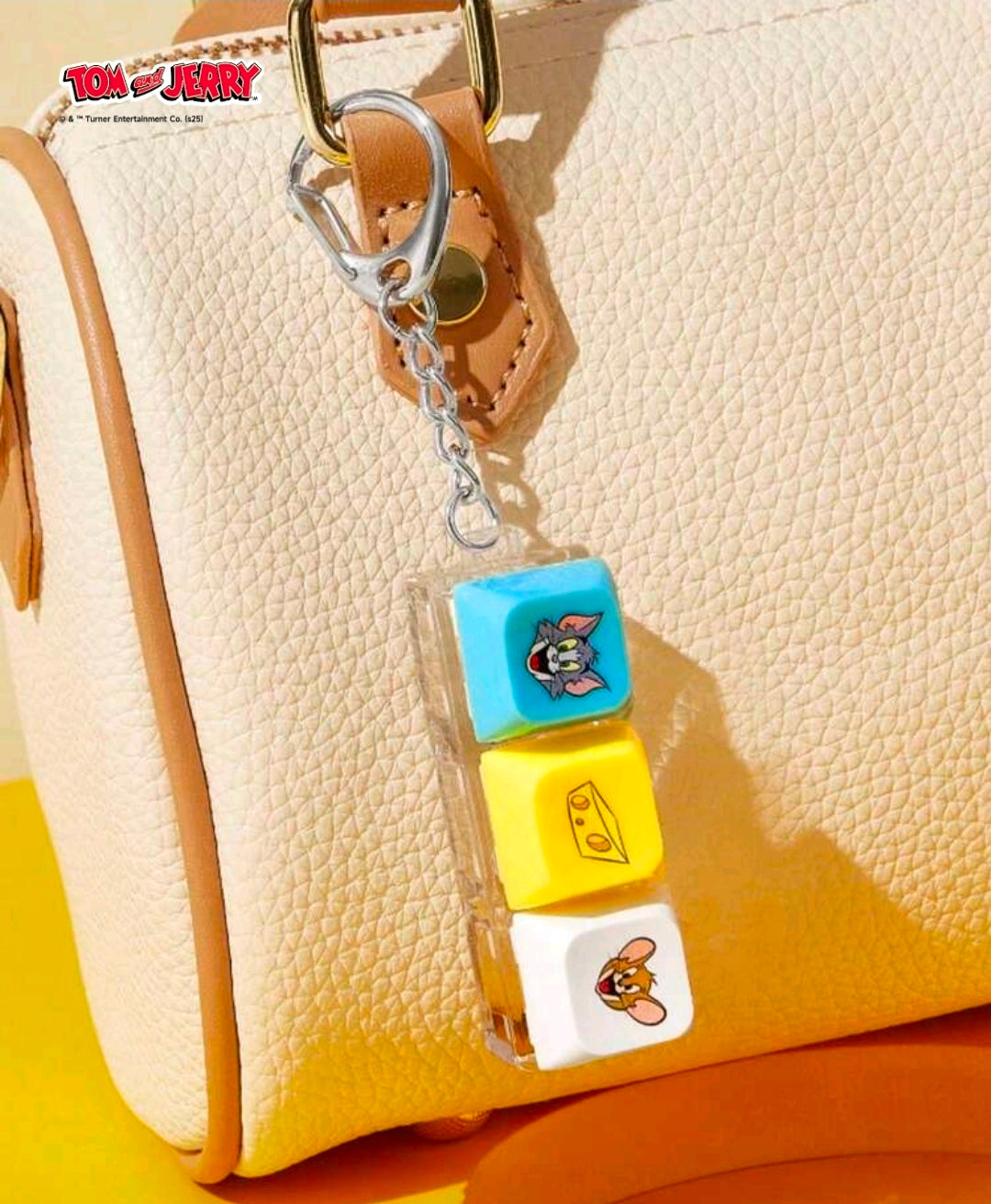 Keychain fidget clicker attached to a clip; blue, yellow, and white blocks