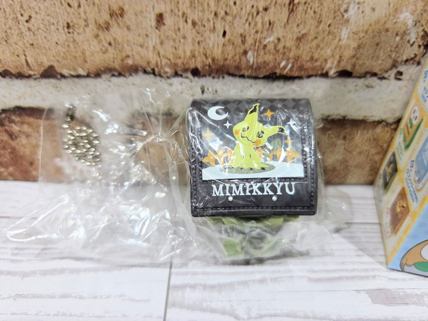 Sealed mini school bag figure with dark gray Mimikyu front label and green side