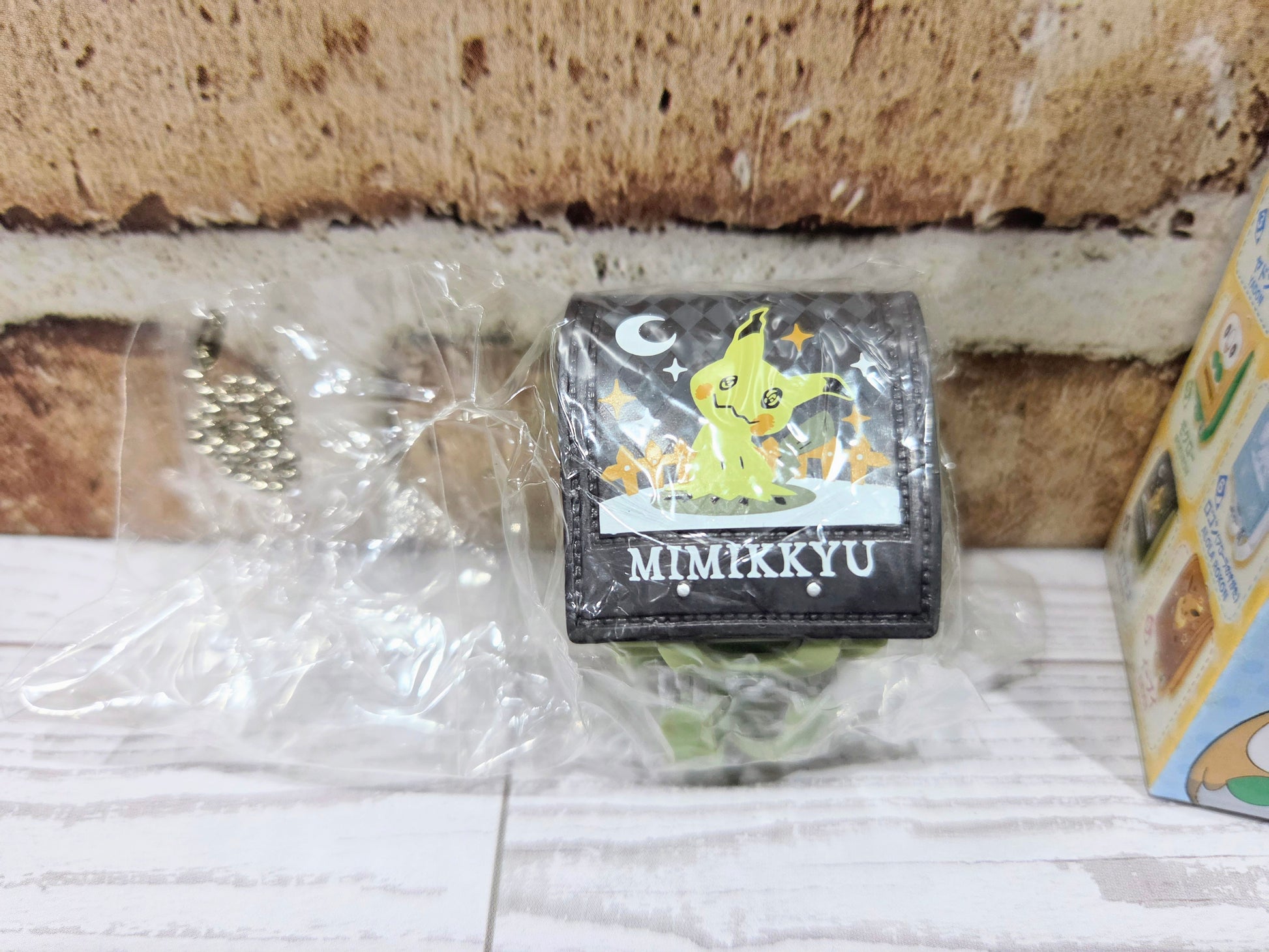 Sealed mini school bag figure with dark gray Mimikyu front label and green side