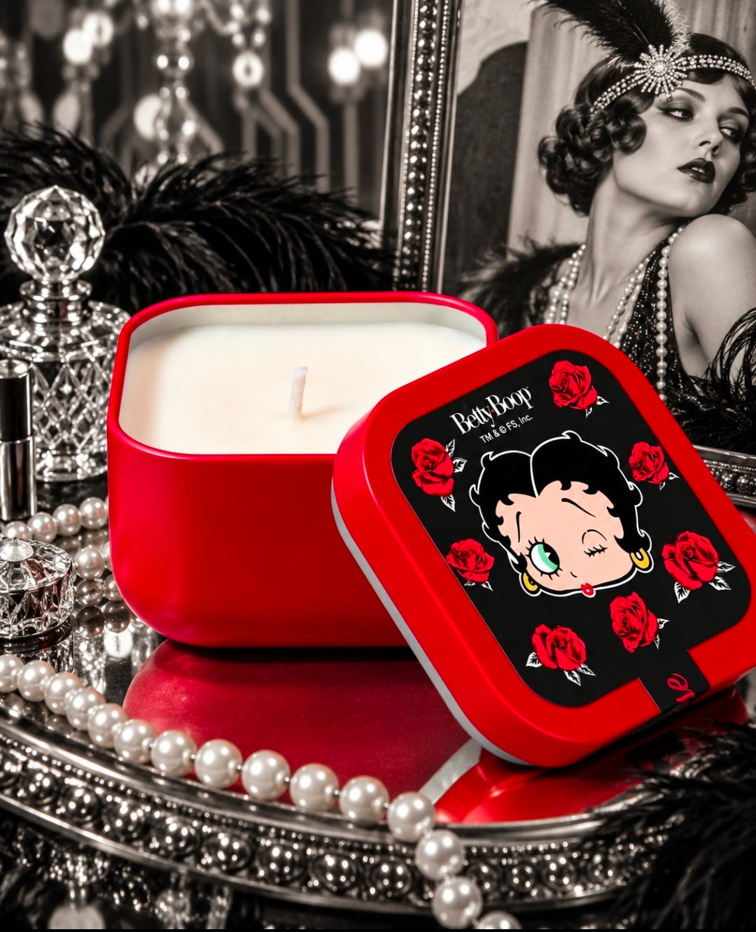 Red square candle tin with Betty Boop rose lid; candle wick visible