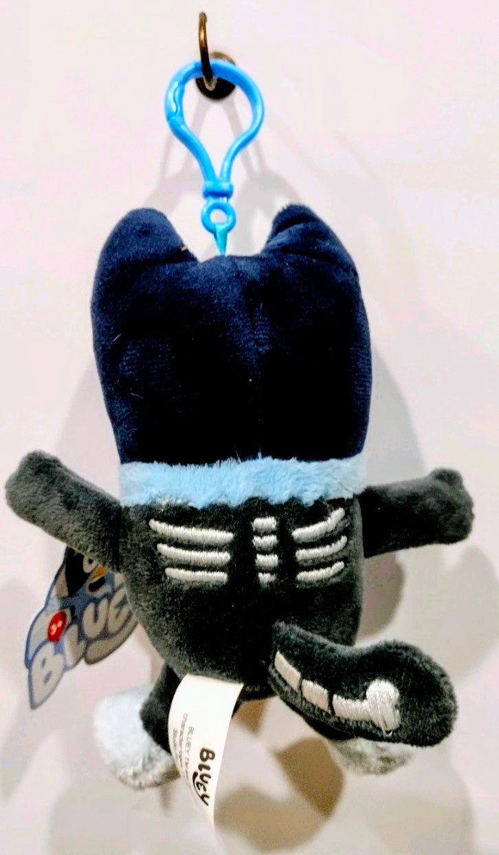 Black Halloween plush keychain with skeleton belly stripes and hanging tag