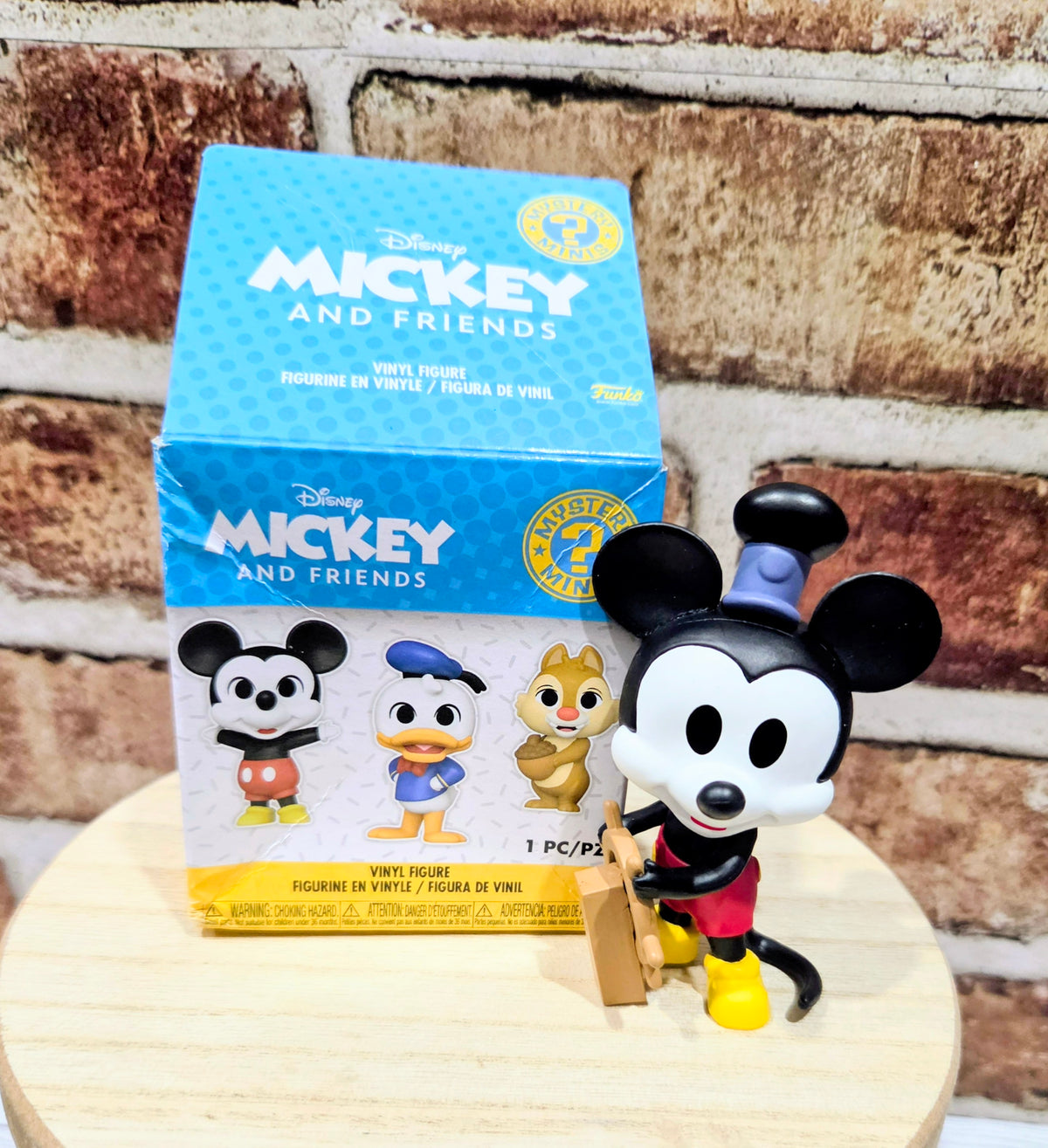 Mickey Mouse mini vinyl figure posed with Mickey and Friends mystery minis box