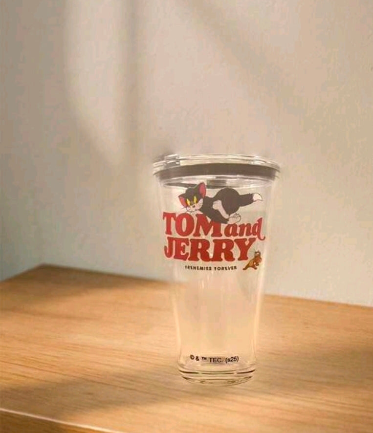 Clear tumbler with Tom and Jerry graphic on front and black lid