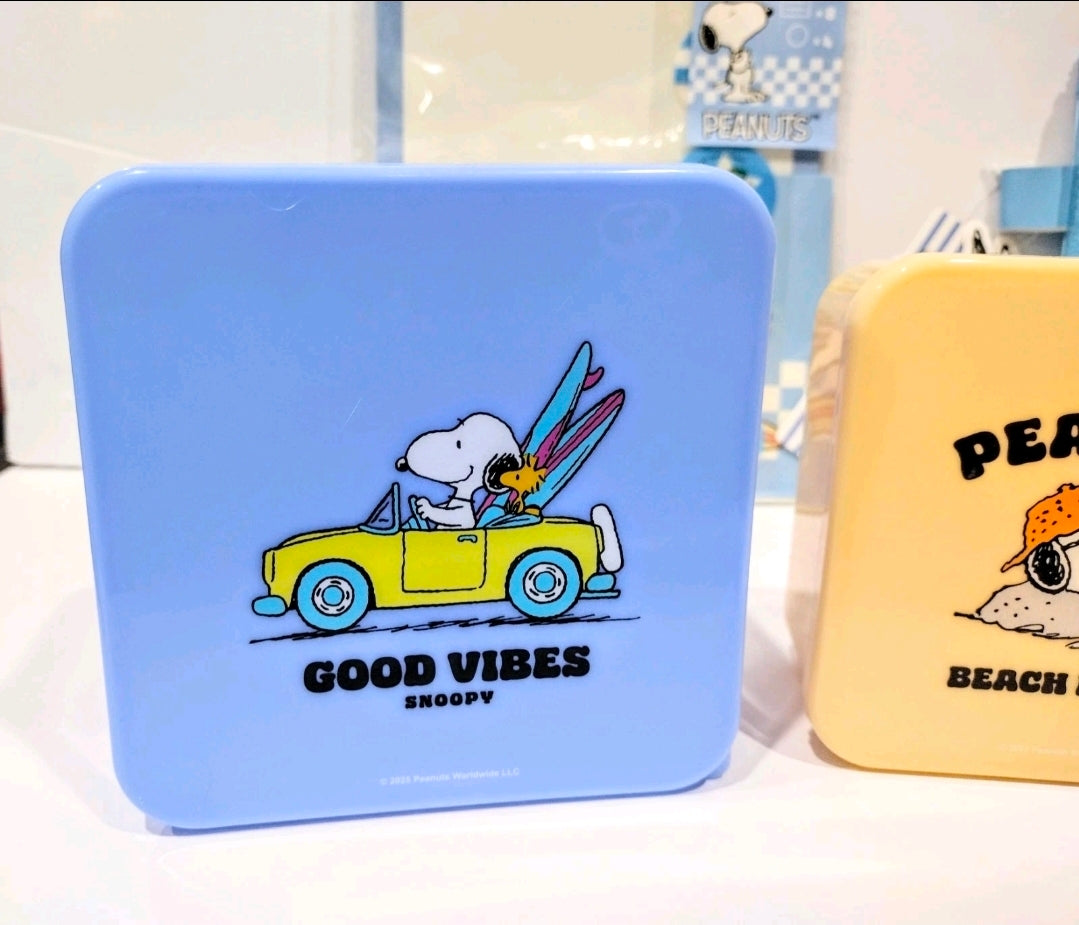Blue mini storage tin with Snoopy in a car and “GOOD VIBES” text