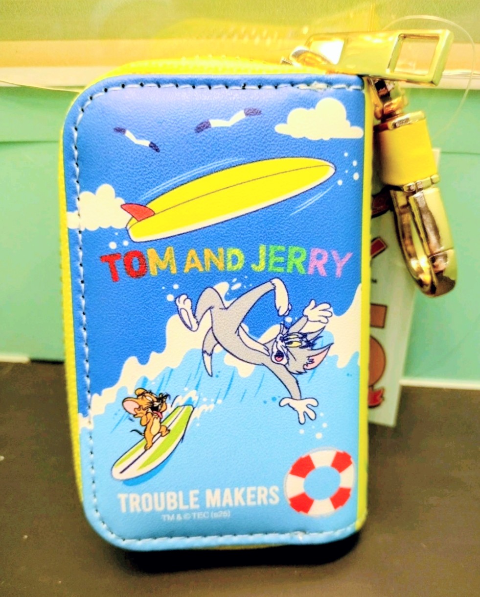 Blue smart key case with “TOM AND JERRY” text, surfboard scene, and key clip