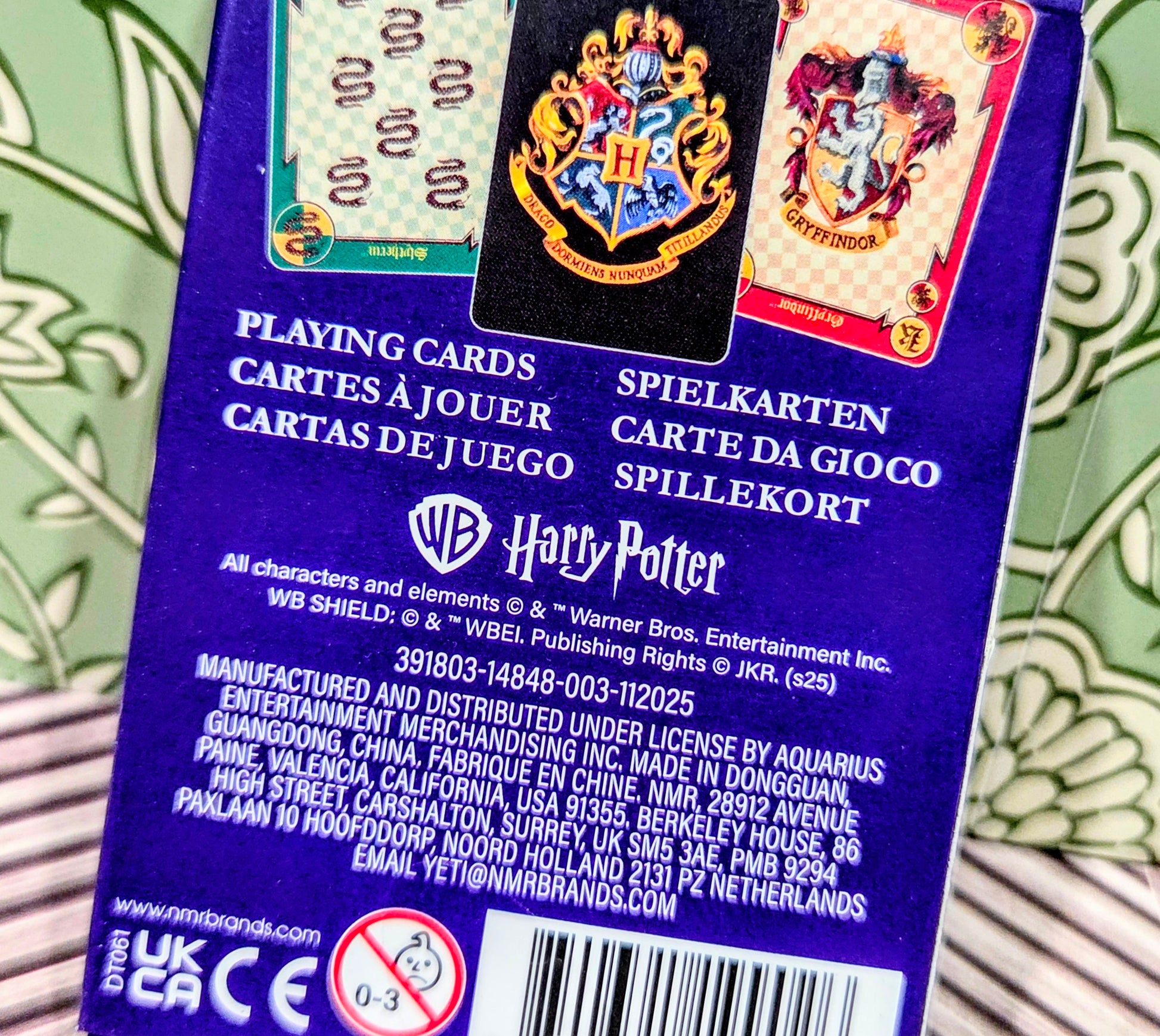 Playing cards deck back panel close-up with Hogwarts crest and house card artwork