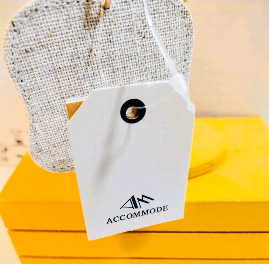 Grey fabric keychain pouch with white Accommode tag and black logo