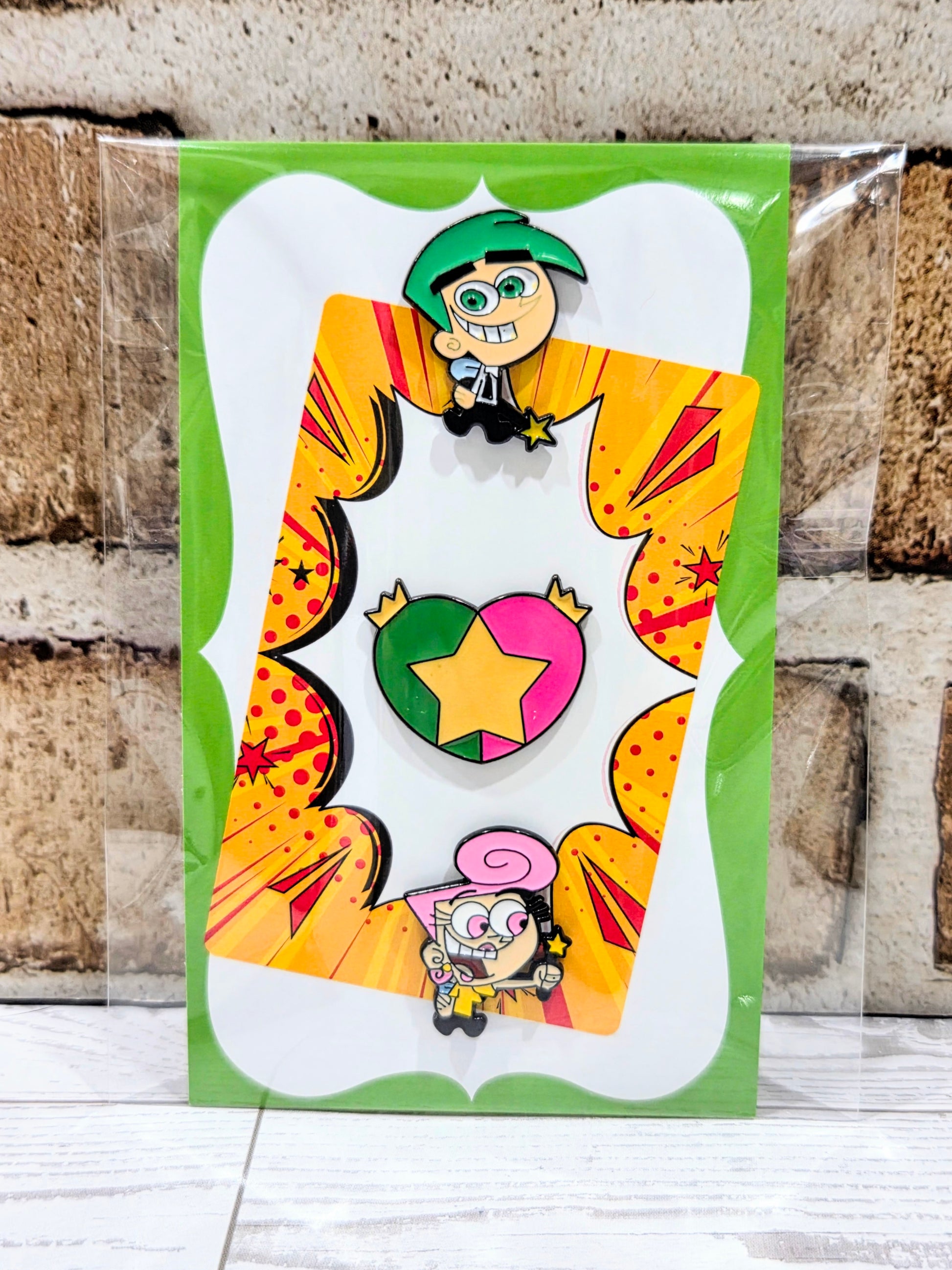 Enamel pin set card with three pins: Timmy character, star-heart, and Wanda.