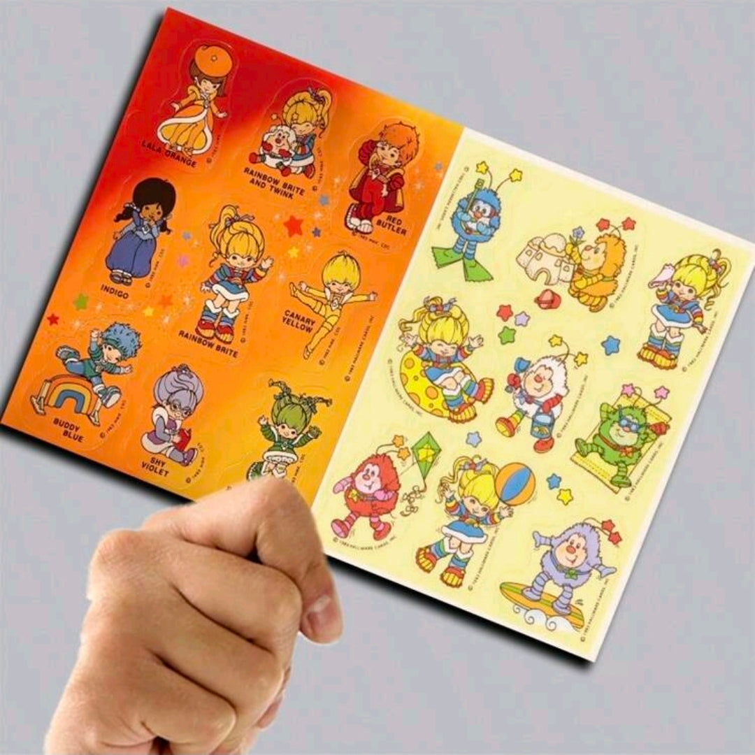 Rainbow Brite scrapbook paper pad with colorful character sheets, opened with patterned pages