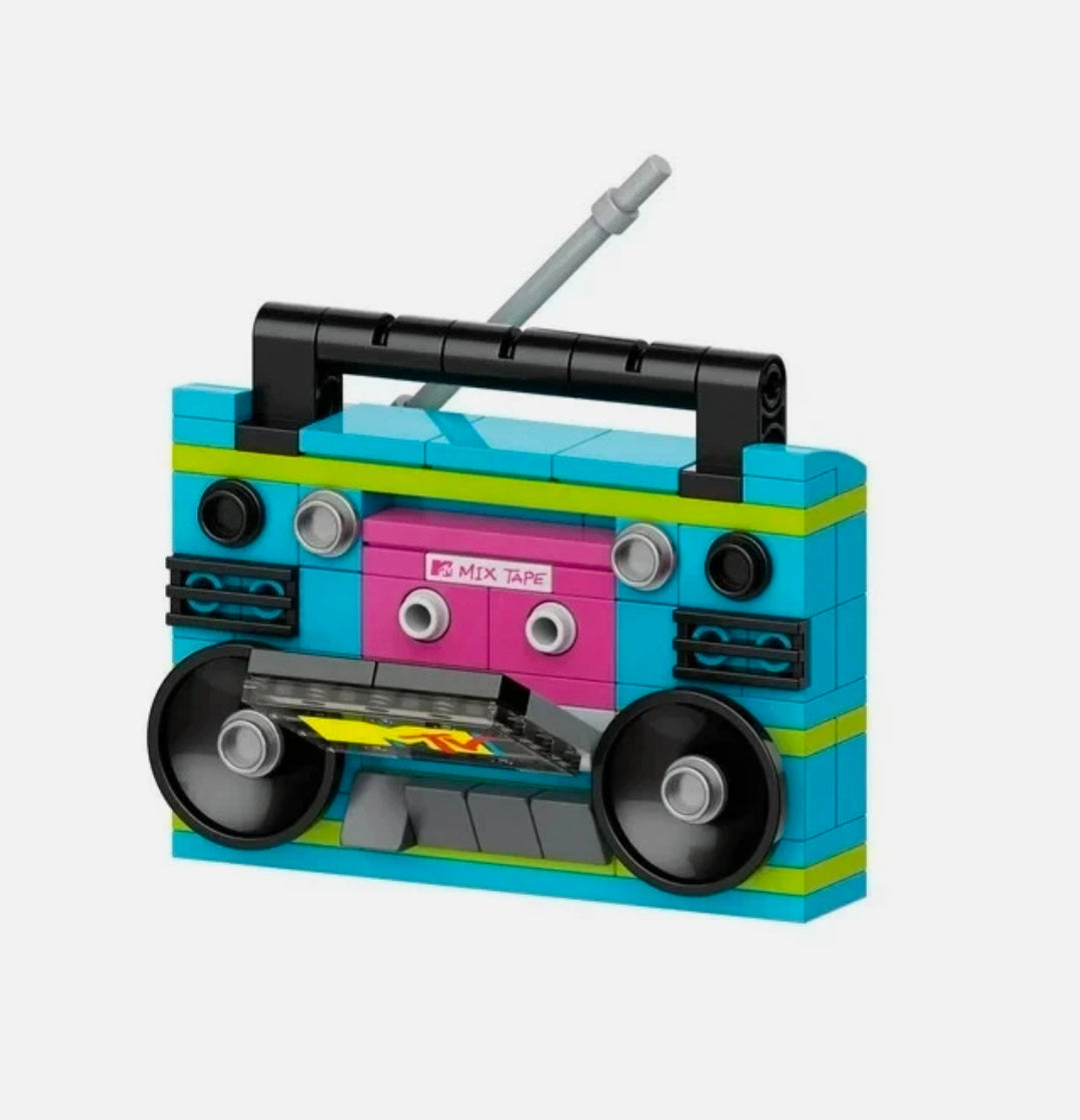 Turquoise MTV boombox brick model with pink mixtape panel, black speaker wheels