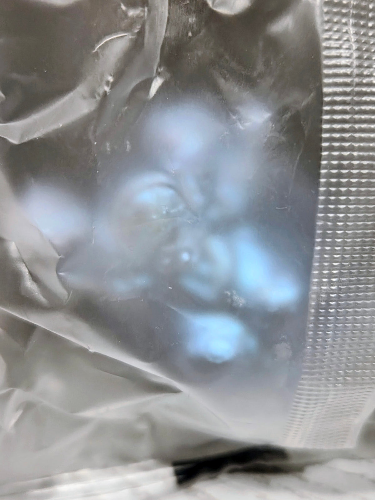 Silver foil-wrapped mini figure bundle with translucent blue tint