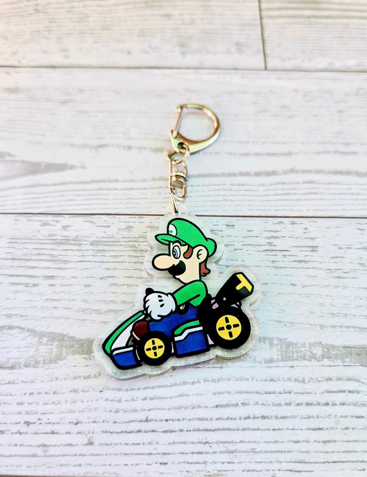 Luigi racing acrylic keychain with gold ring, die-cut on clear backing