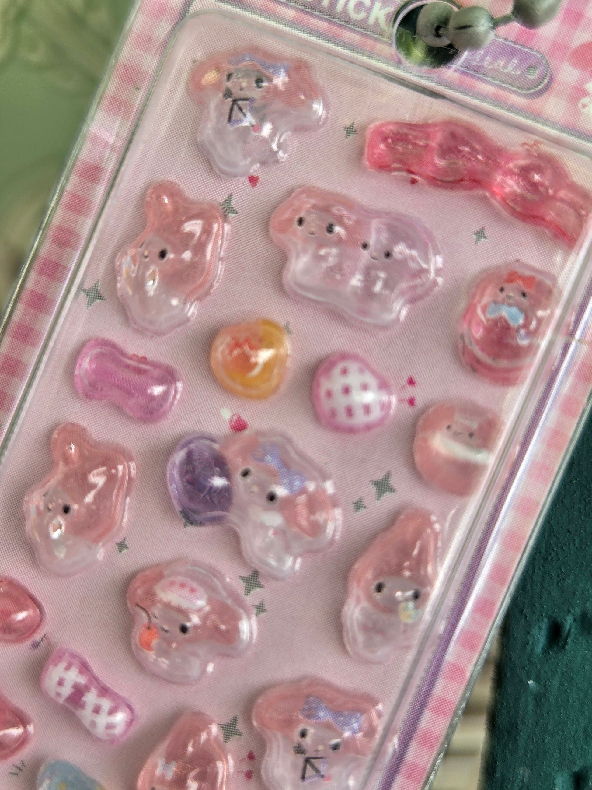 Clear blister pack with pink 3D character stickers and a small sticker keychain tag