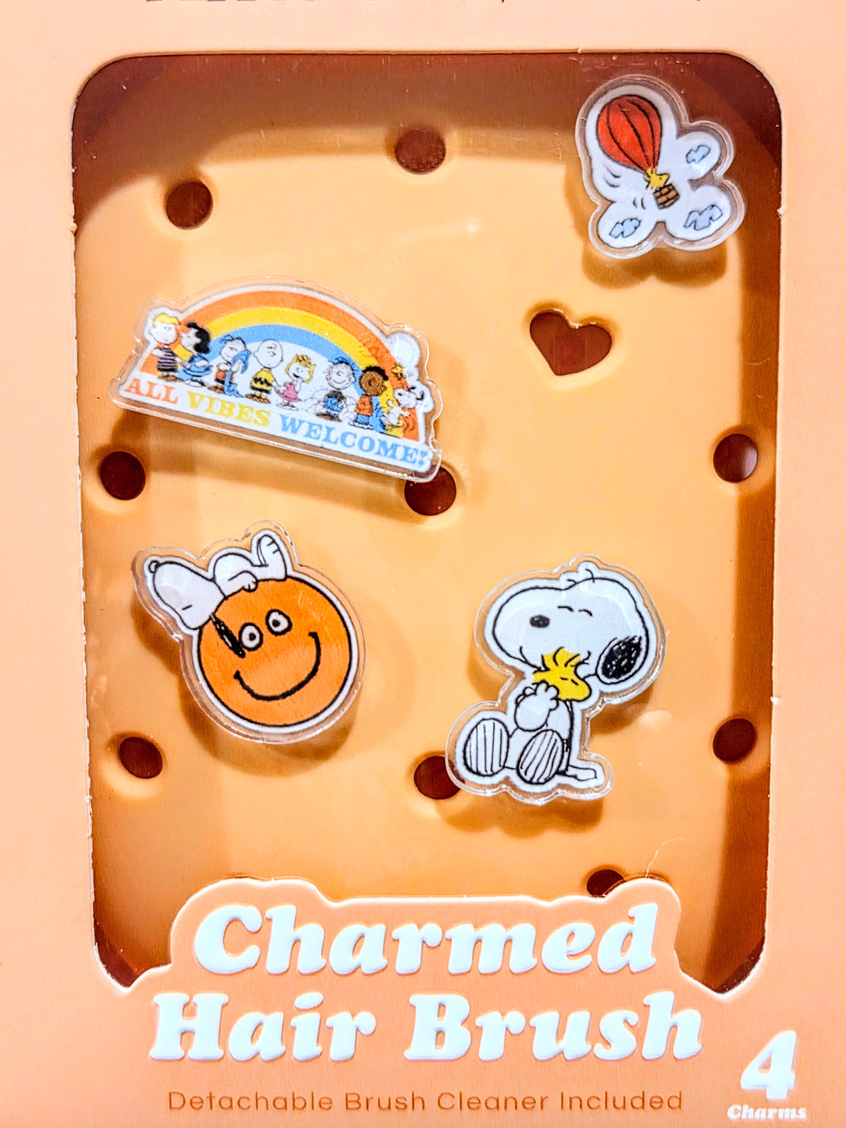 Charmed hair brush packaging tray with four acrylic charms and 'Charmed Hair Brush' text