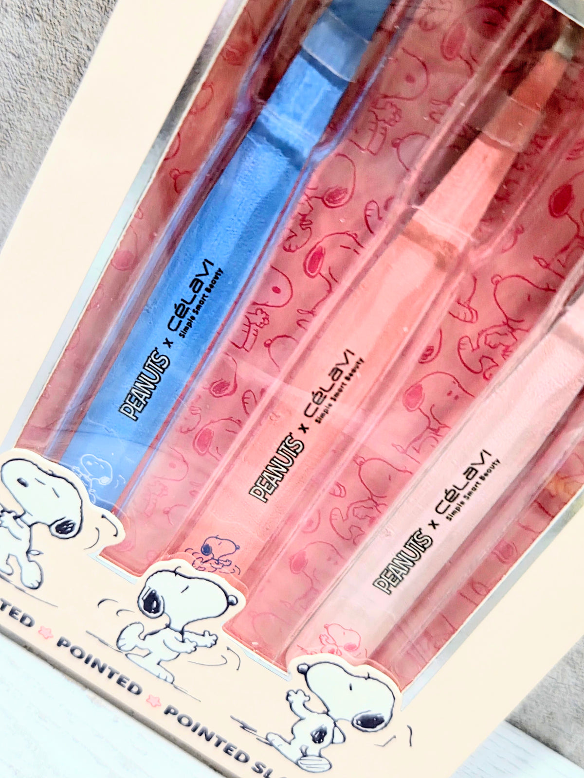 Clear blister pack showing three tweezers with blue, pink, and red grips