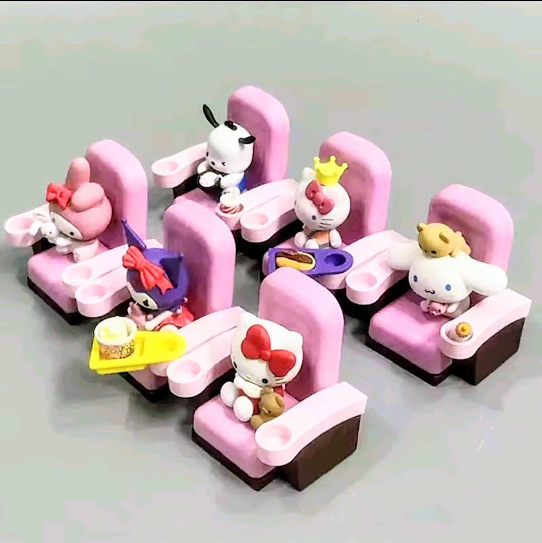 Assorted mini character figures sitting on pink theater chairs with accessories