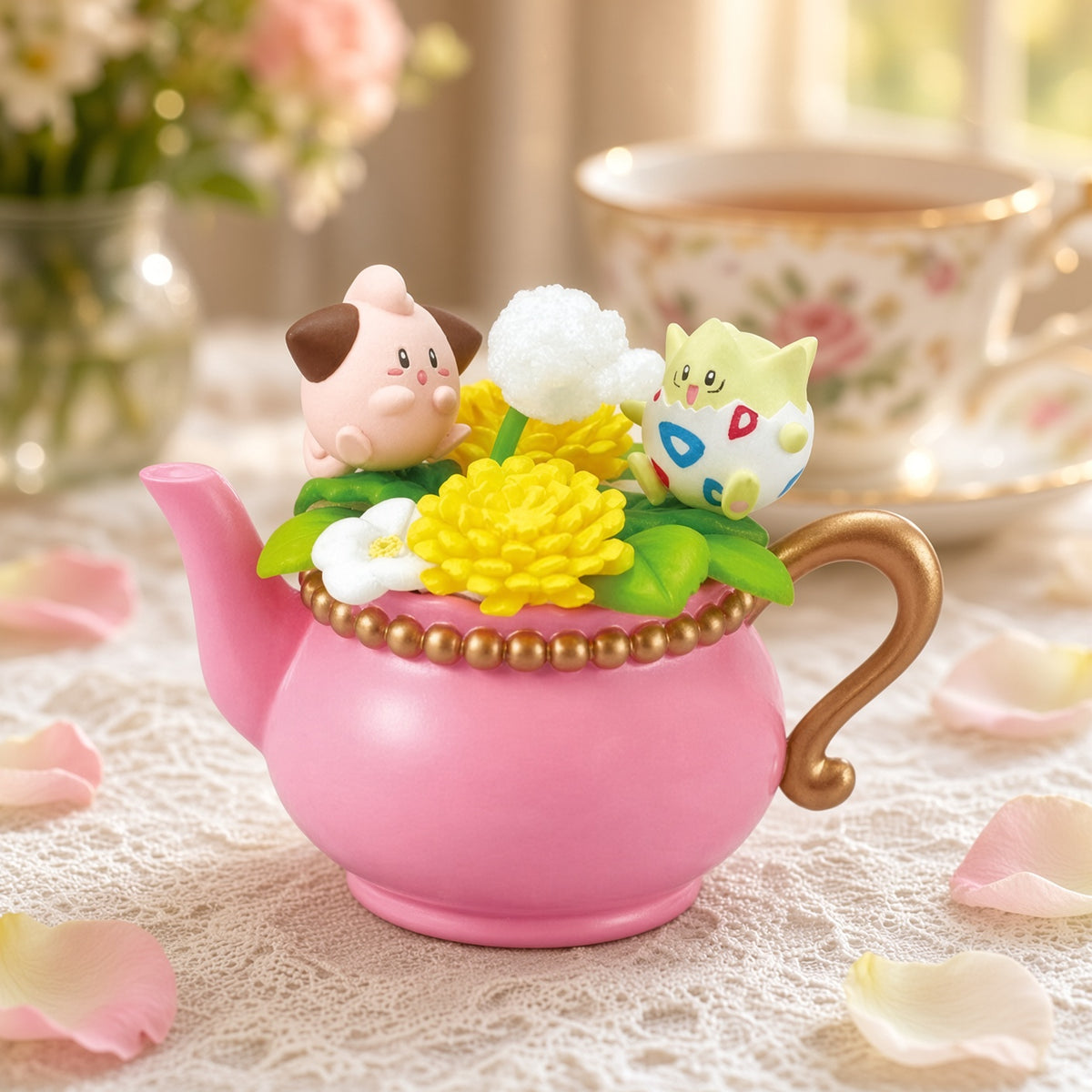 Pink teapot mini figure with white and yellow flower topper on bead trim