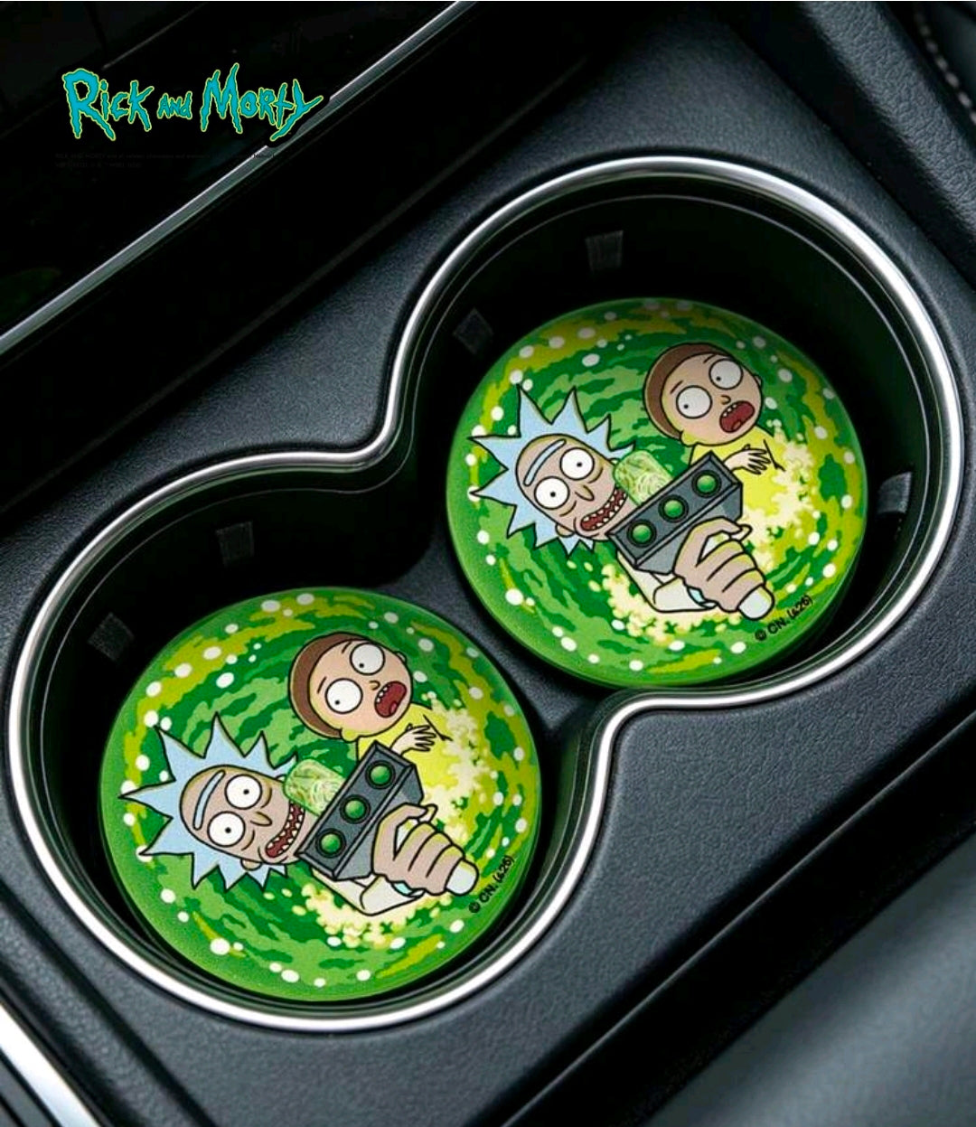 Two green round Rick & Morty coasters in a car cup holder, portal swirl design