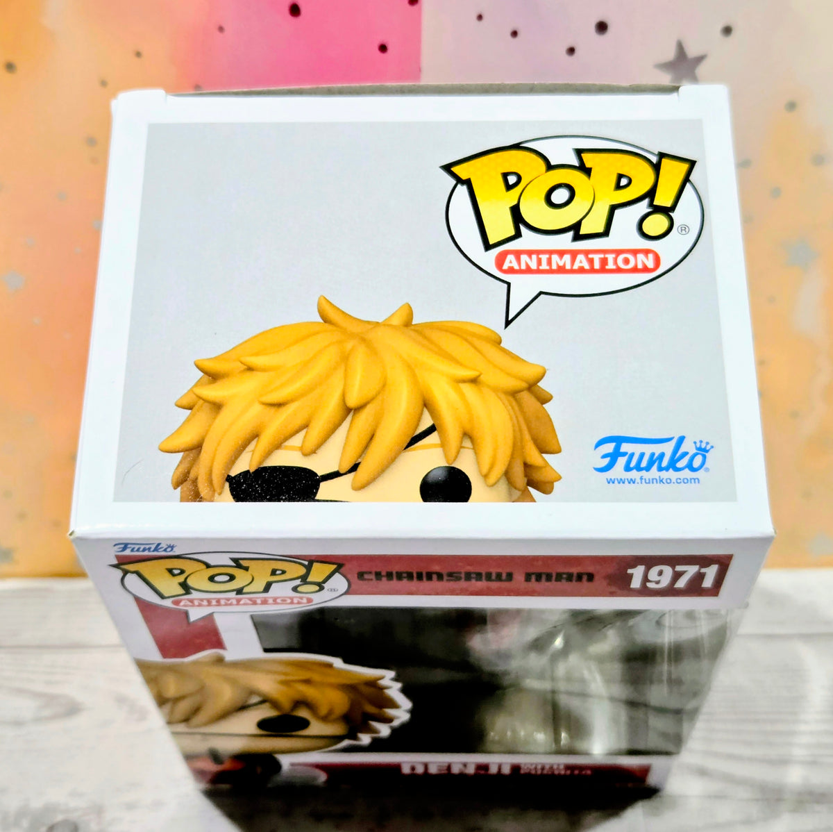 Funko Pop! Animation vinyl figure box with blonde hair character and red accessory visible through window