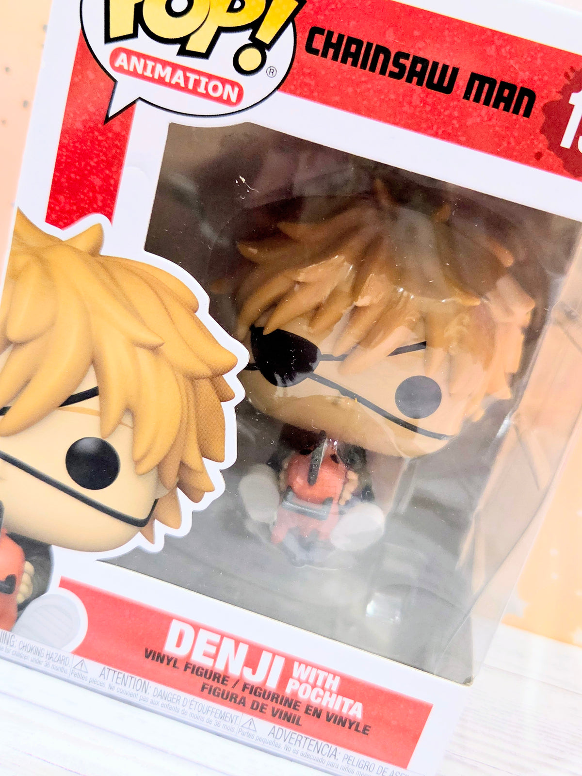 Funko Pop! Animation vinyl figure box close-up window showing blond hair and black eyes with Pochita