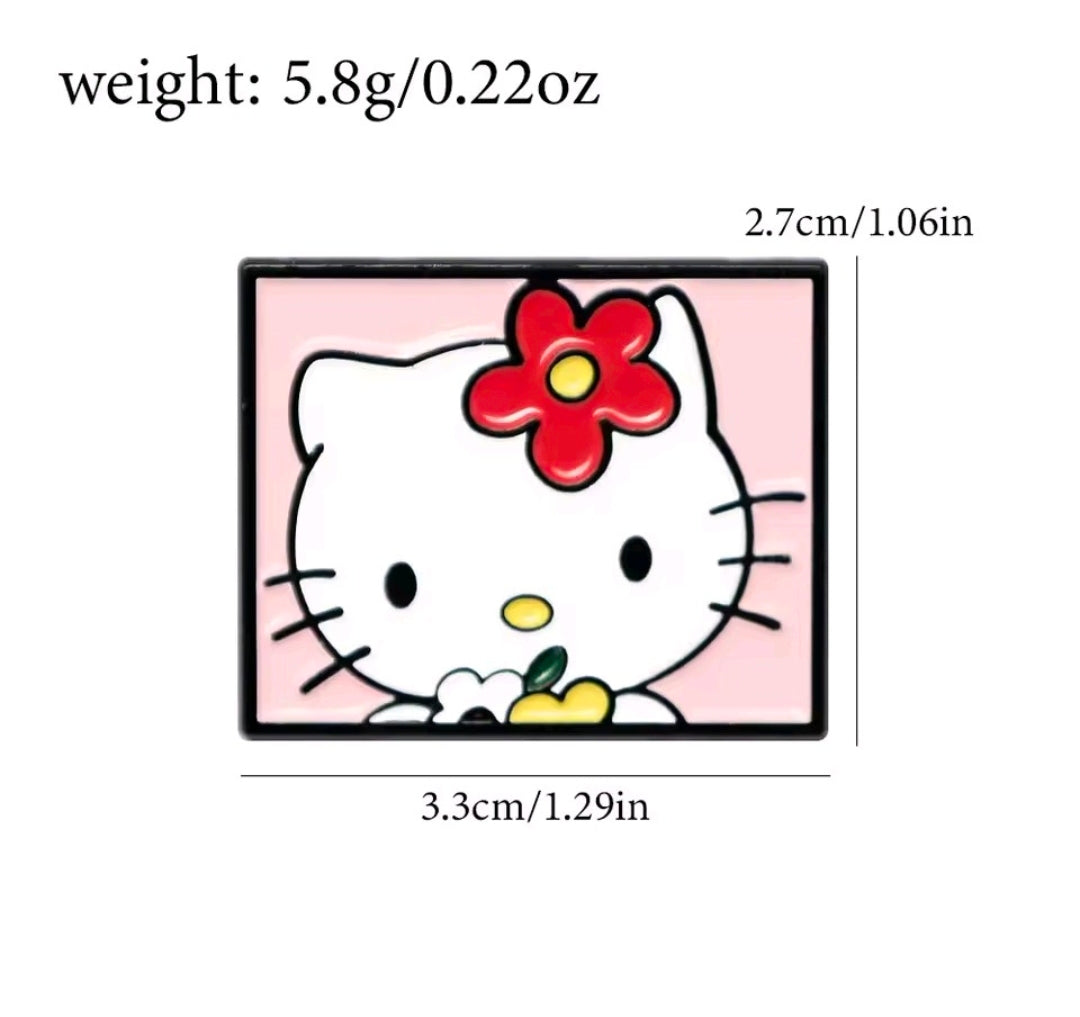 Hello Kitty enamel pin with red bow and whiskers, pink background, black frame