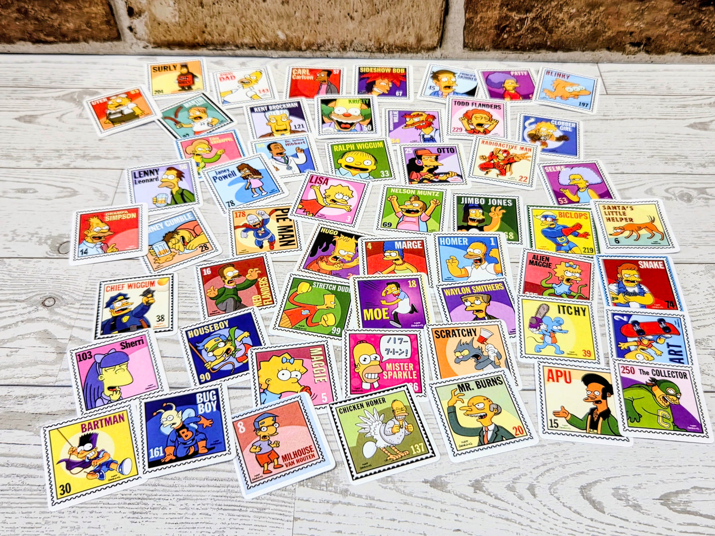 Simpsons postage-stamp style sticker sheet layout with many character face decals on light background