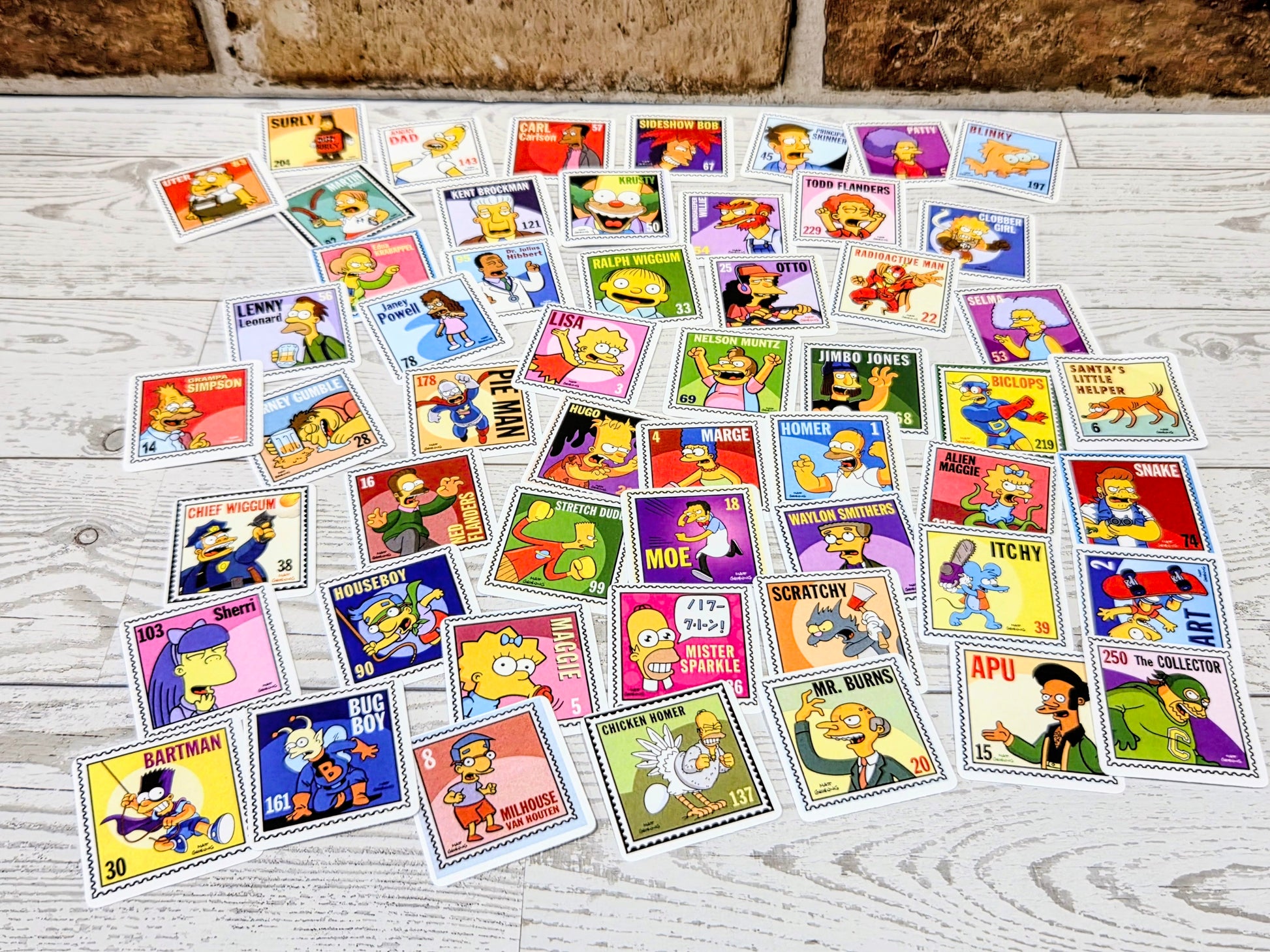 Simpsons postage-stamp style sticker sheet layout with many character face decals on light background