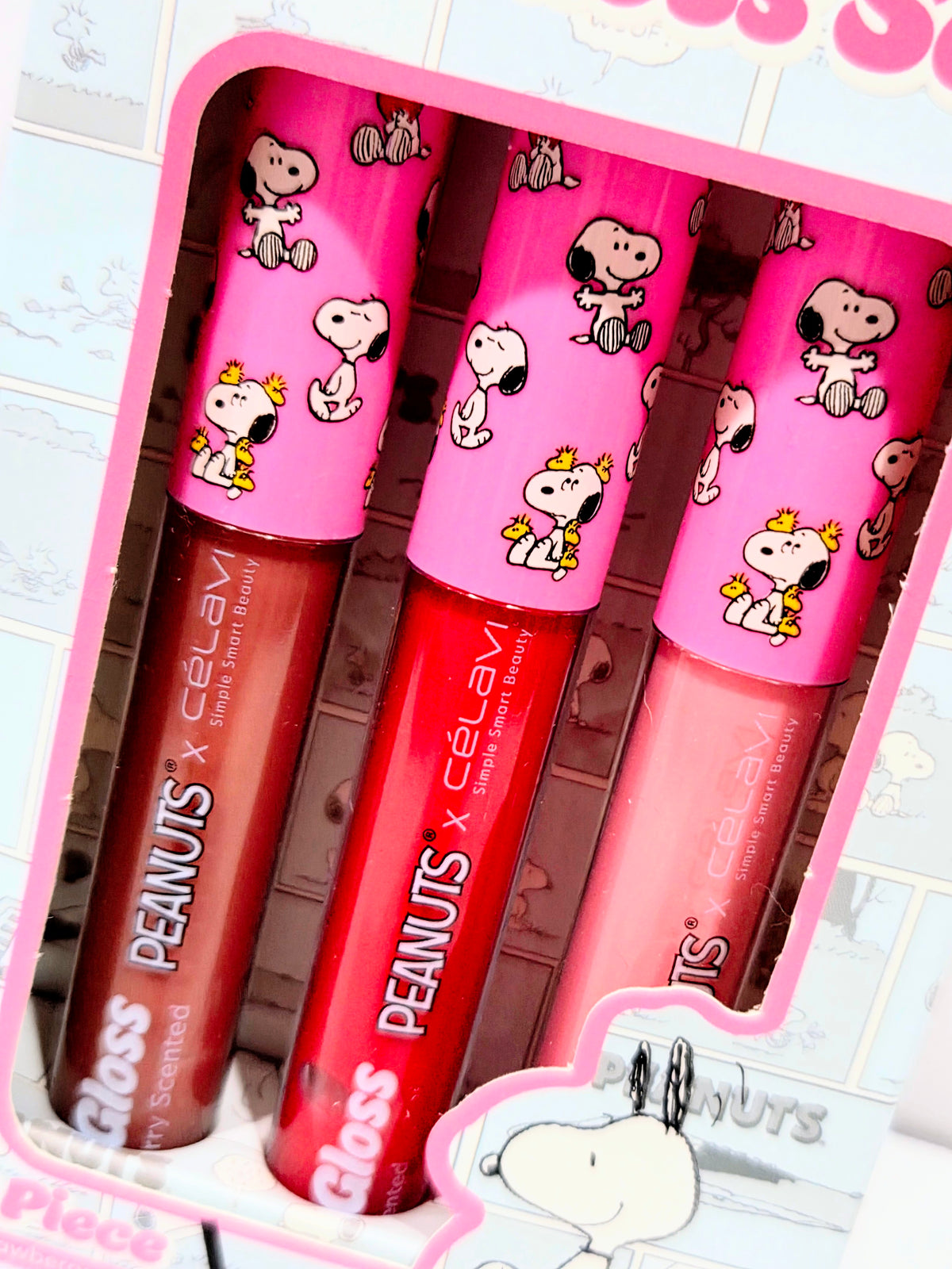 Open 3-piece lip gloss set showing three Snoopy-printed pink and red tubes