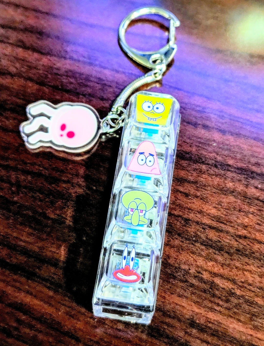 Clear acrylic keyboard fidget keychain with hand charm, keyring, and SpongeBob character panels