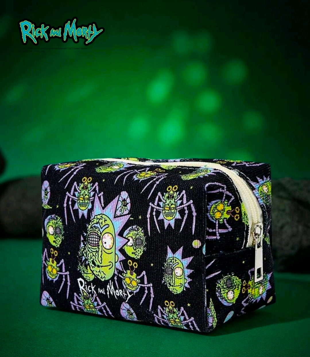 Black zippered makeup pouch with colorful character print and raised border detail.