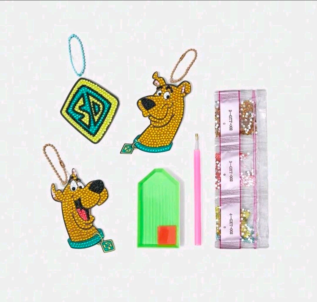 Diamond painting ornament kit pieces: two dog charms, diamond icon, green tray, bead packet
