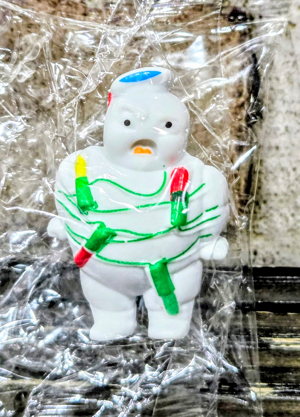 White Mini-Puft ghost figure in green striped suit with red and yellow side accents