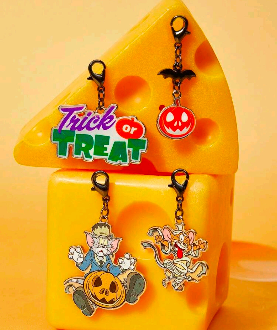 Set of 4 Halloween bag charm clips with Trick or Treat sign and pumpkin-faced cartoon charms