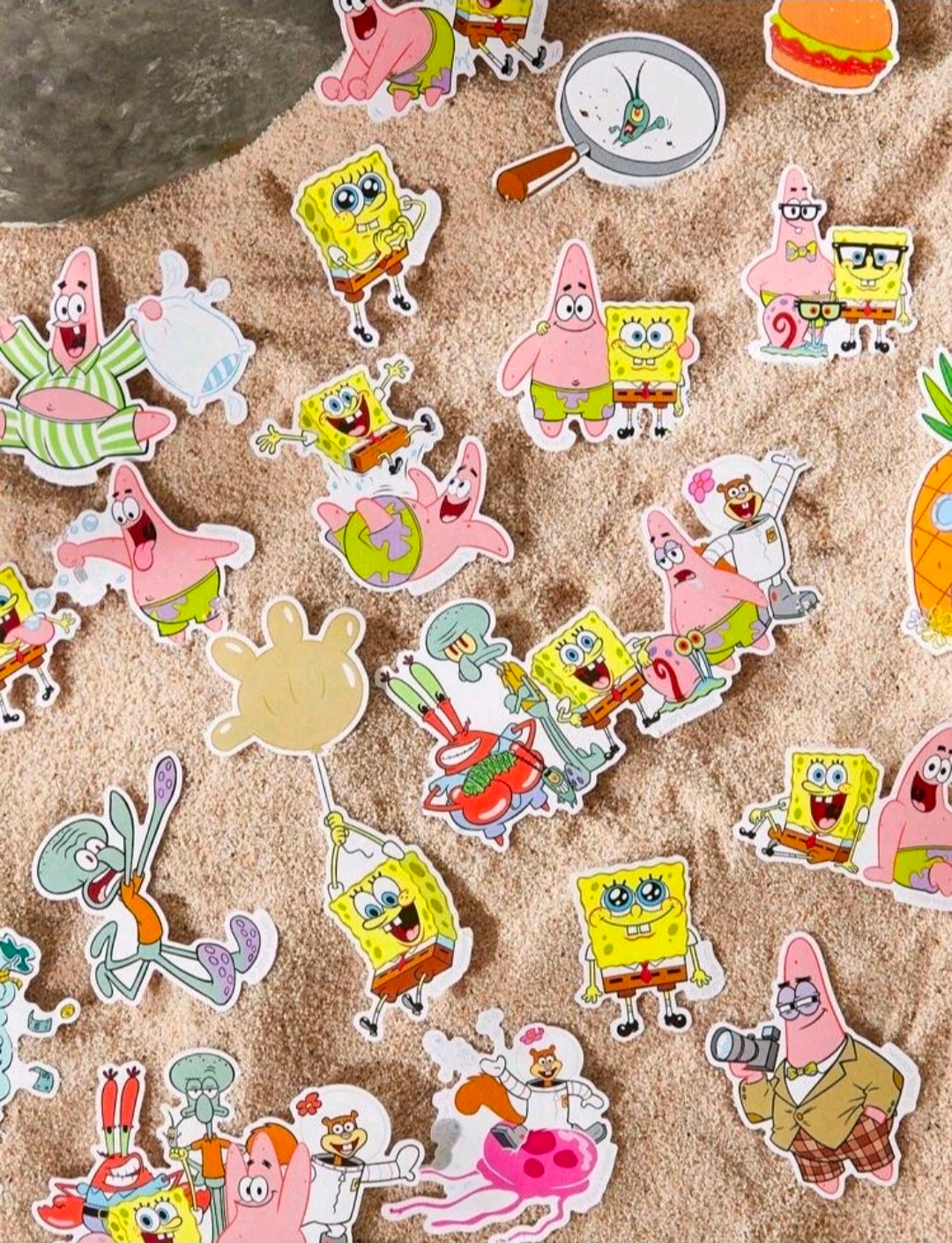 Chibi character sticker assortment scattered on a textured surface