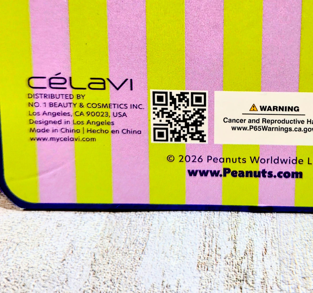 Peanuts x Célavi gift bundle package back with stripes, QR code, and warning label