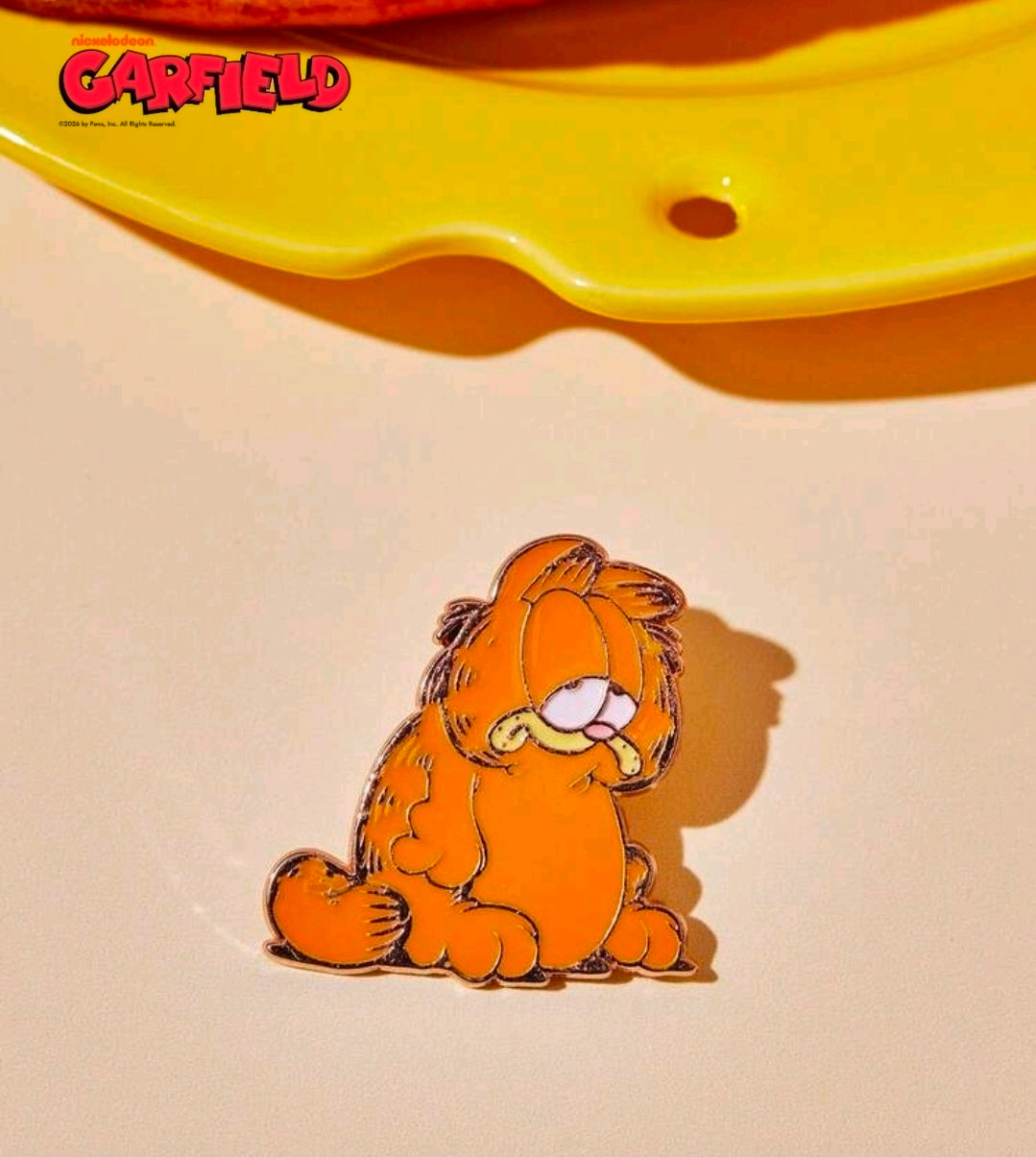 Enamel character pin of an orange striped cat with a heart, gold-outlined