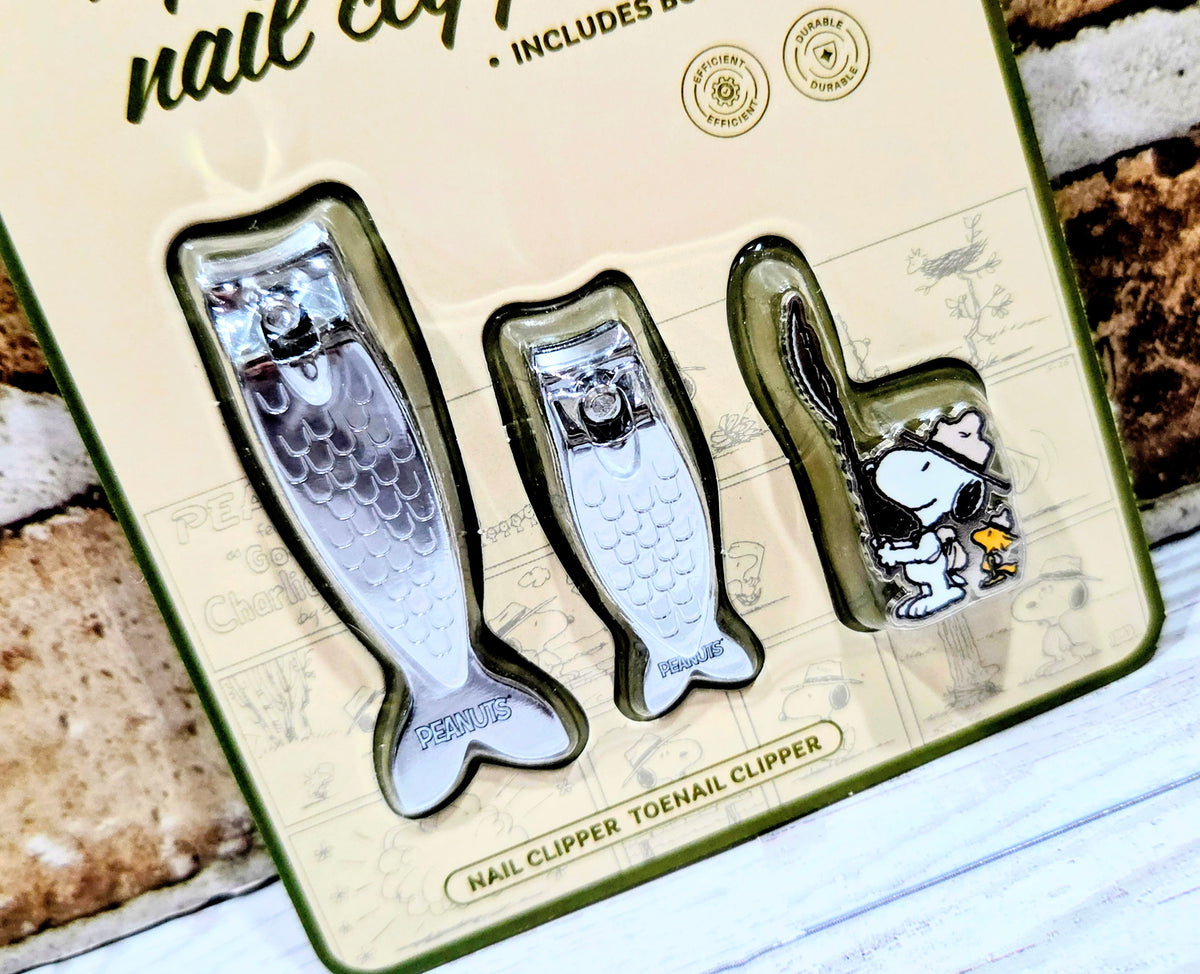 Tray with large and small fish-shaped nail clippers plus Snoopy enamel pin