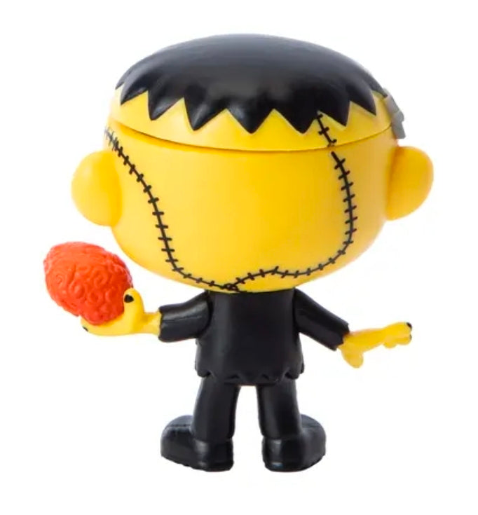 Chibi vinyl Halloween figure close-up, yellow stitched face, jagged black hat, stitched smile
