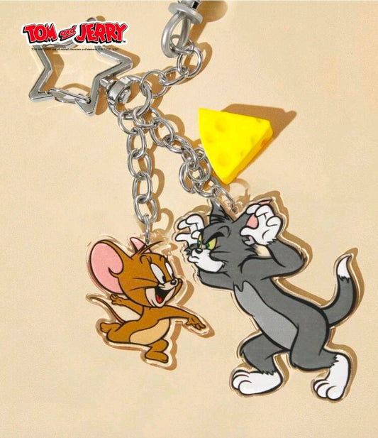 Tom & Jerry claw grabber keychain with star topper, chain, and yellow triangle charm
