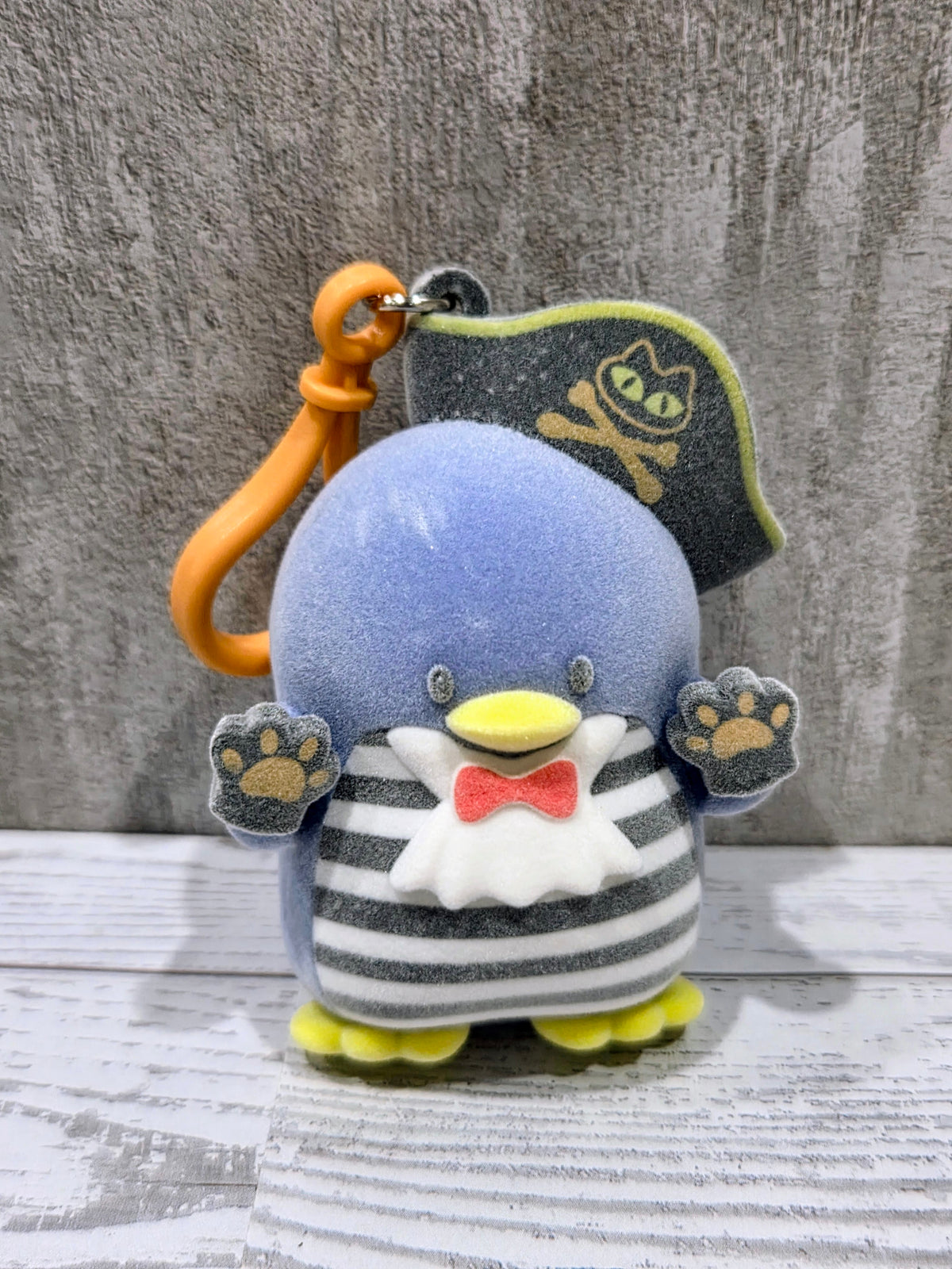 Blue Tuxedo Sam plush bag clip with pirate hat, orange loop, and striped belly