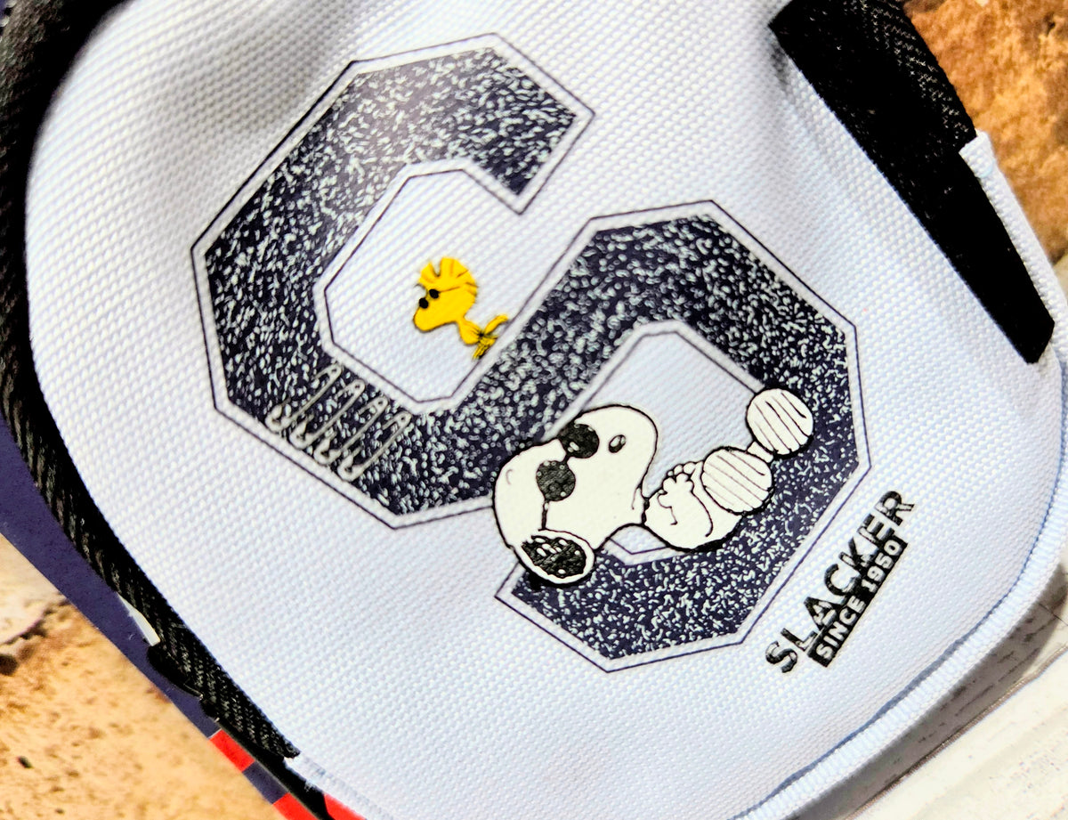 Snoopy graphic keychain bag with black zipper and “Slacker Since 1950” text