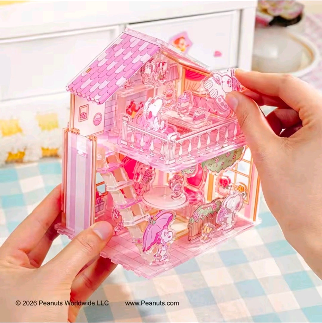 Pink acrylic puzzle house being held, with detailed balcony and interior