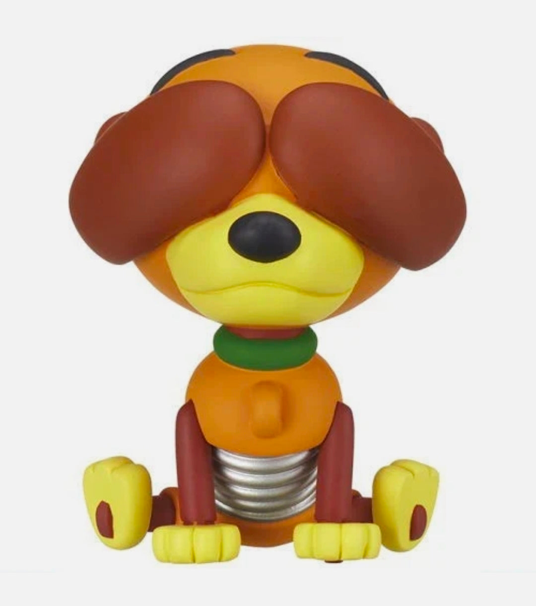 Yellow dog gashapon figure with brown arms, green collar, and spring belly