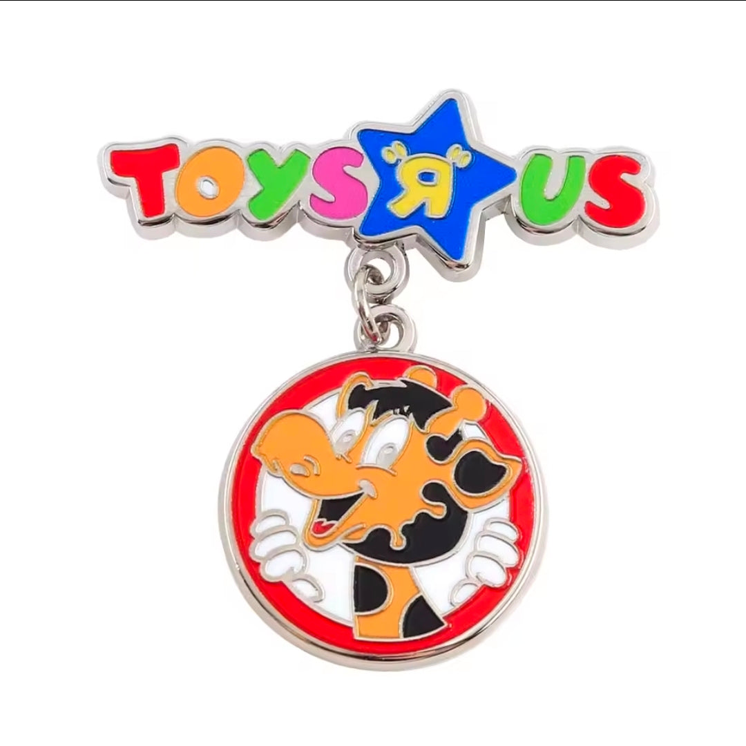 Enamel dangle charm pin featuring Toys R Us star and giraffe face medallion
