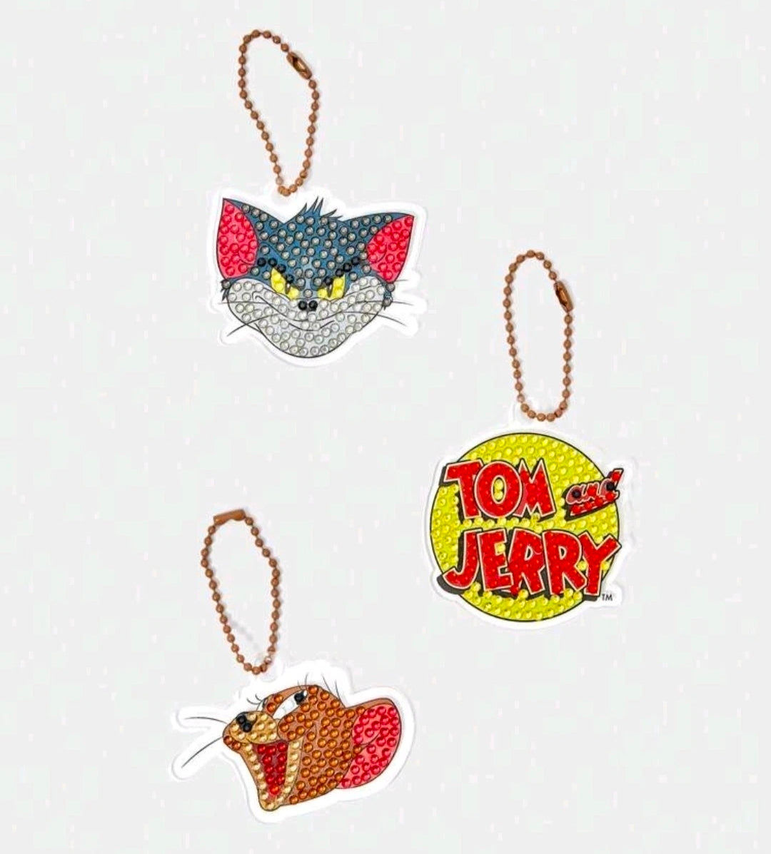 Diamond painting keychain kit featuring cat and Tom and Jerry charms with brown bead loops