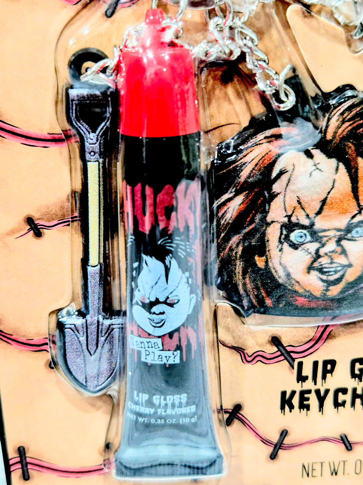 Chucky lip gloss tube with red cap and clear pendant keychain card