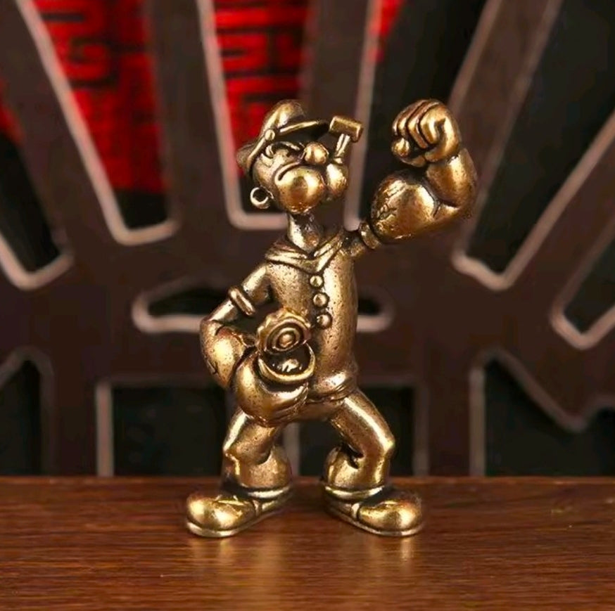 Brass sailor mini statue figure front view, holding a wrench overhead with satchel