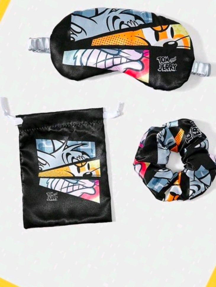 Black satin sleep mask with matching pouch and scrunchie, all with colorful character print